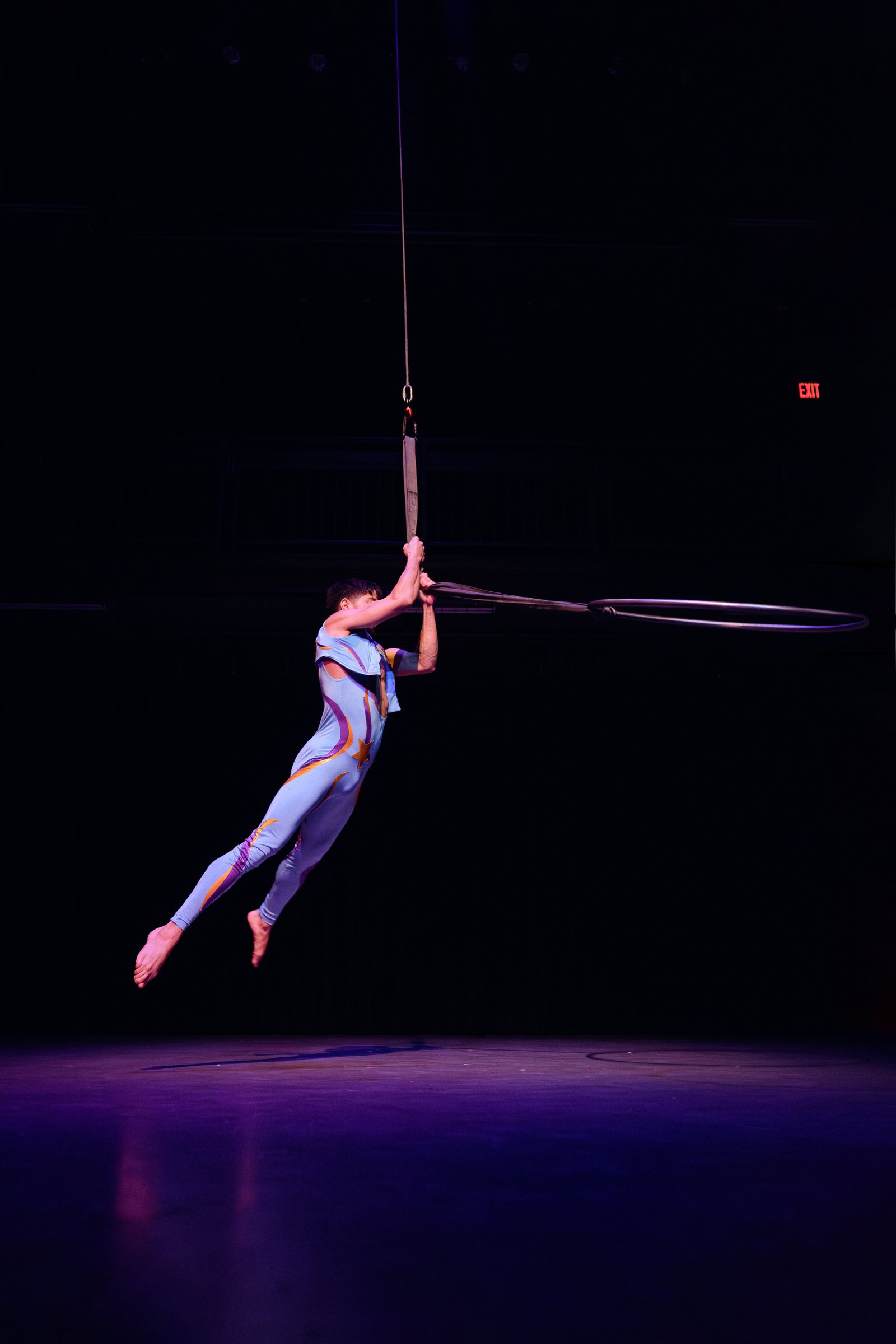 Hooman moving through aerial hoop
